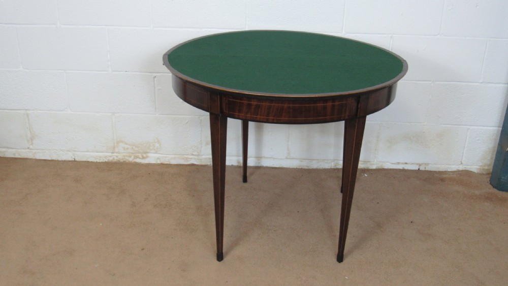 A Georgian mahogany demi-lune card table with linear string inlay and tapered square legs. View VII