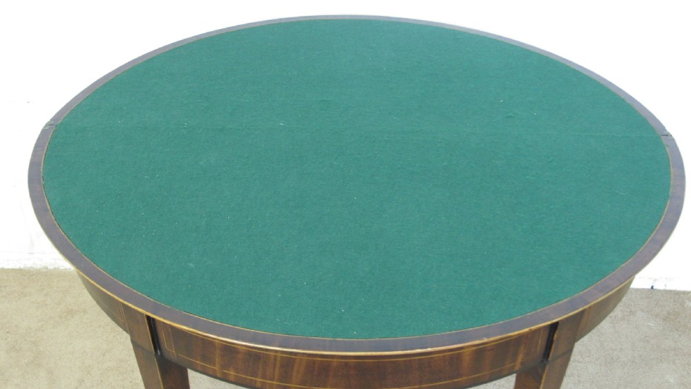 A Georgian mahogany demi-lune card table with linear string inlay and tapered square legs. View VIII