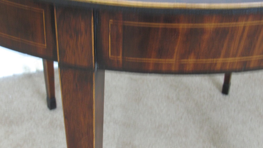A Georgian mahogany demi-lune card table with linear string inlay and tapered square legs. View IX