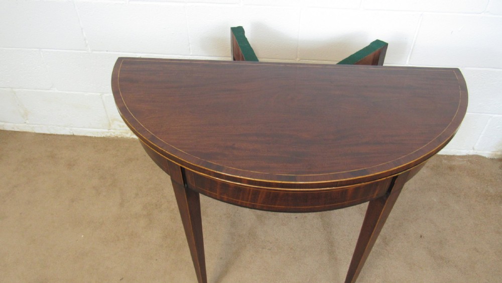 A Georgian mahogany demi-lune card table with linear string inlay and tapered square legs. View XII