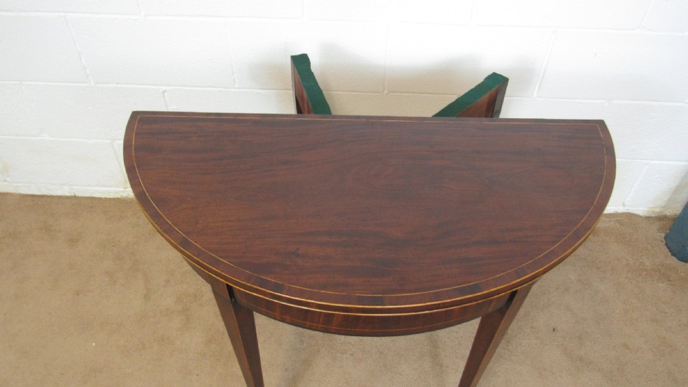 A Georgian mahogany demi-lune card table with linear string inlay and tapered square legs. View XIII