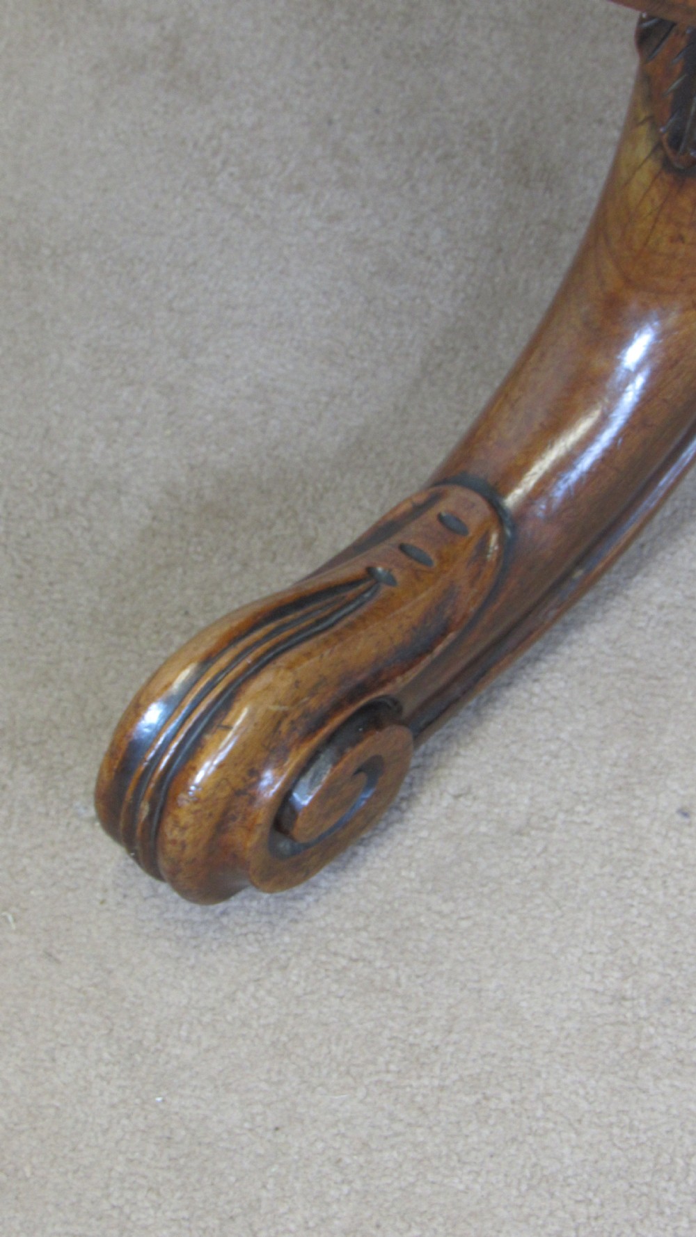 A circular antique rosewood tilt-top table shown in a vertical tilted position, displaying figured timber grain and a carved tripod base. View IV