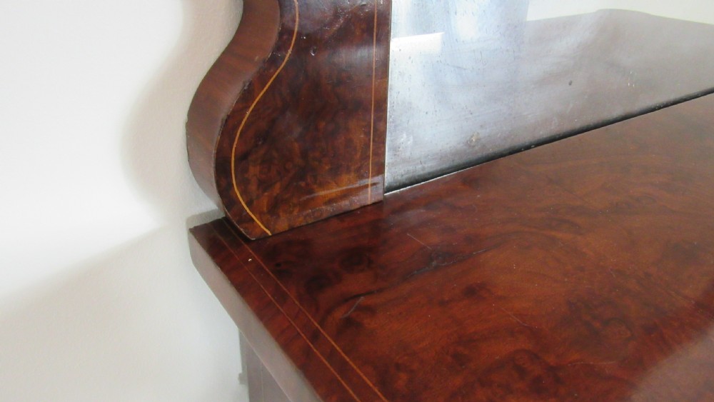Victorian burr walnut pier cabinet featuring a glazed single door, scrollwork marquetry inlay, side columns, and an arched mirror back. View IX