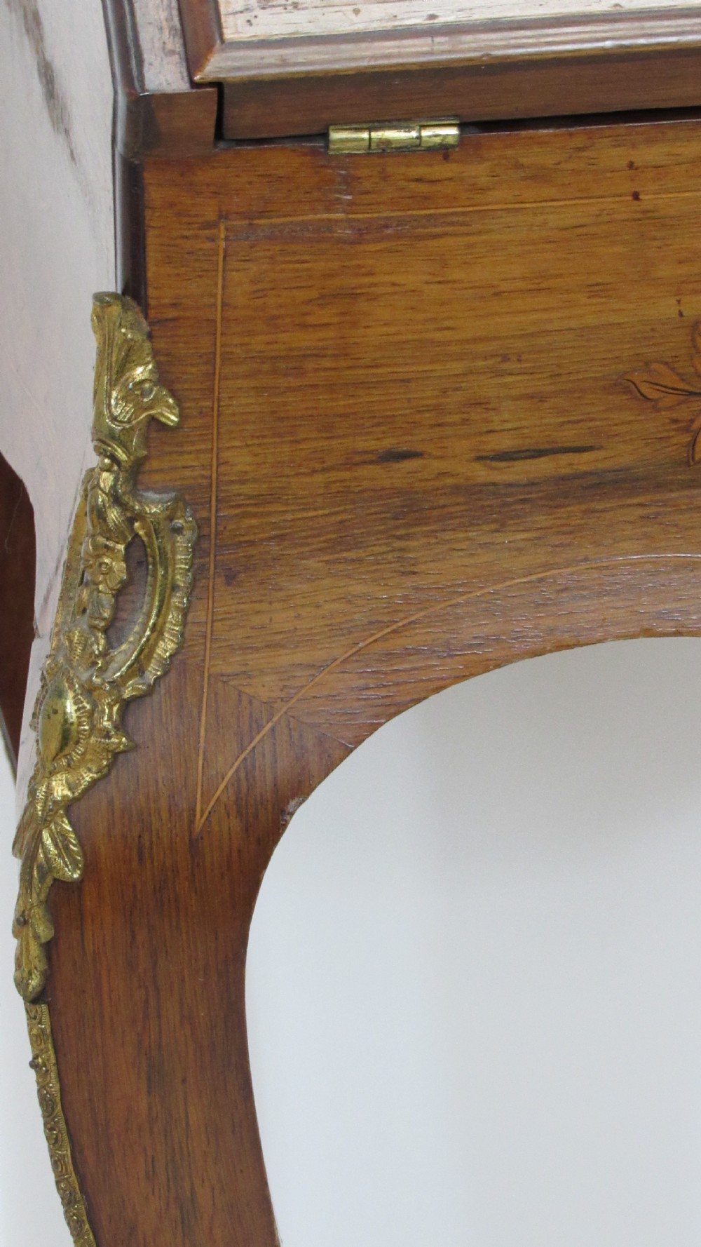 An antique French-style walnut writing bureau with floral marquetry, cabriole legs, brass mounts, and a upper cabinet section featuring small glazed doors and a central mirror. View II