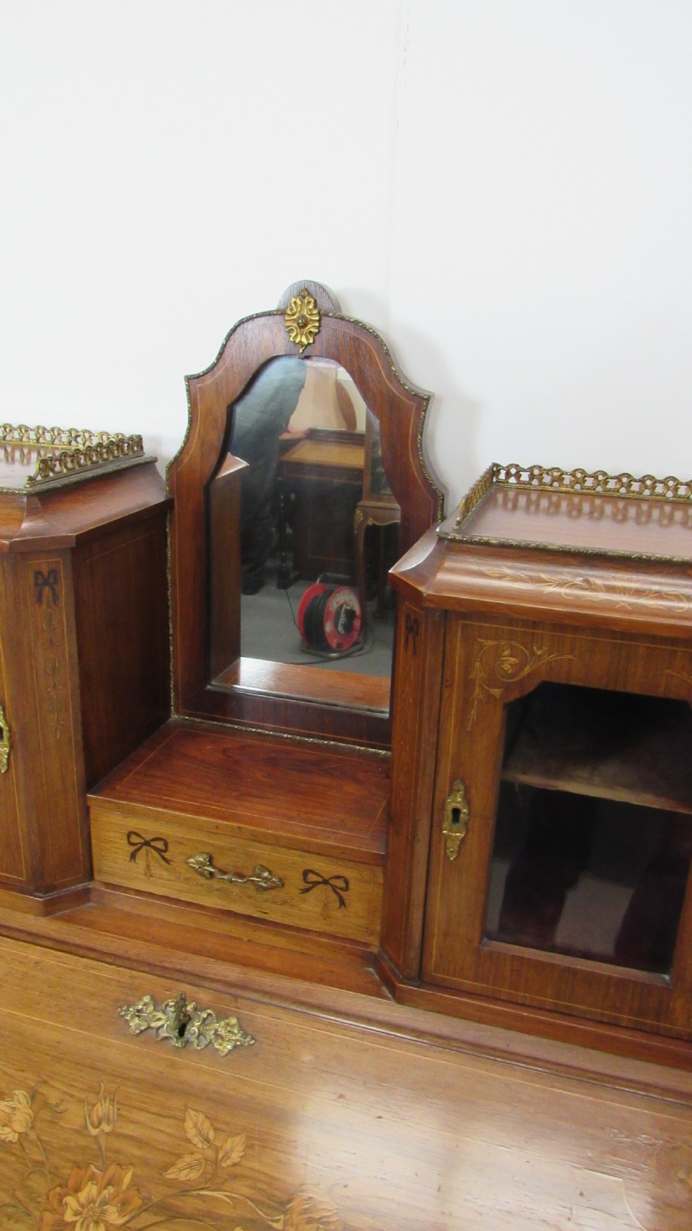 An antique French-style walnut writing bureau with floral marquetry, cabriole legs, brass mounts, and a upper cabinet section featuring small glazed doors and a central mirror. View VII