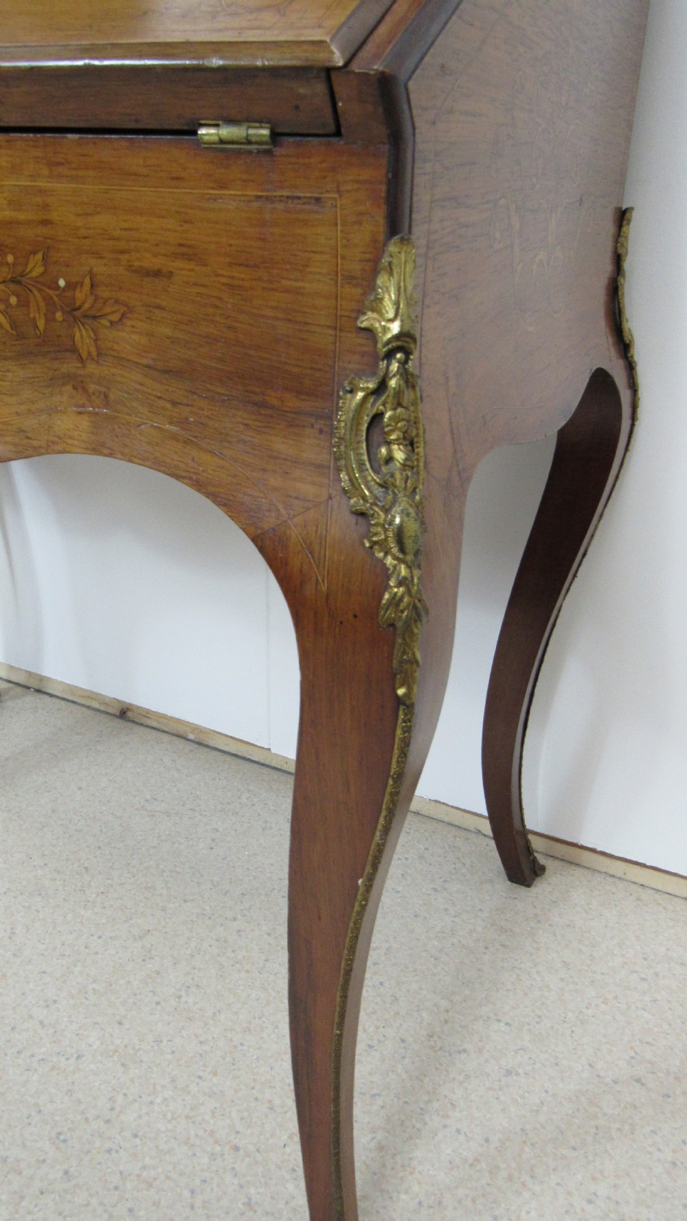An antique French-style walnut writing bureau with floral marquetry, cabriole legs, brass mounts, and a upper cabinet section featuring small glazed doors and a central mirror. View IX