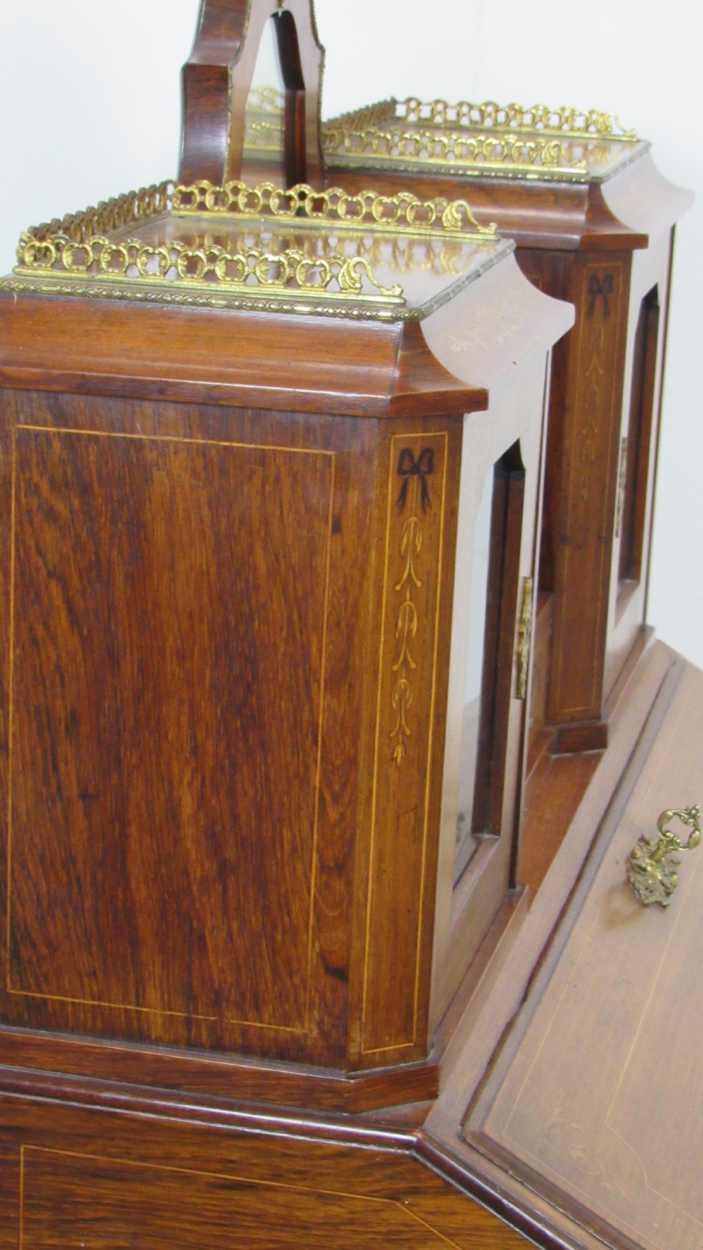 An antique French-style walnut writing bureau with floral marquetry, cabriole legs, brass mounts, and a upper cabinet section featuring small glazed doors and a central mirror. View XII