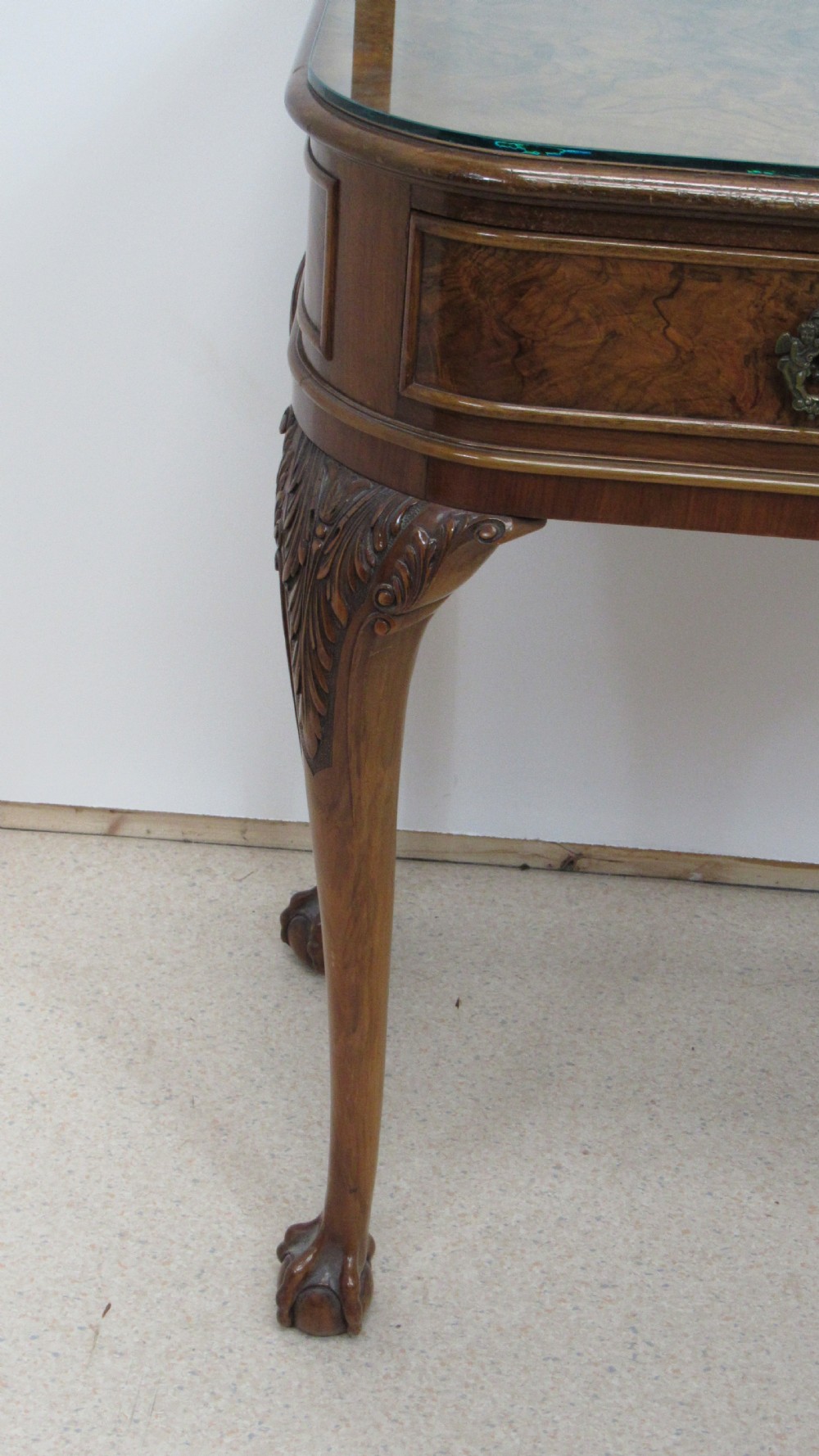 An antique burr walnut side table featuring cabriole legs with claw and ball feet, a single drawer, and a fitted glass top insert. View III