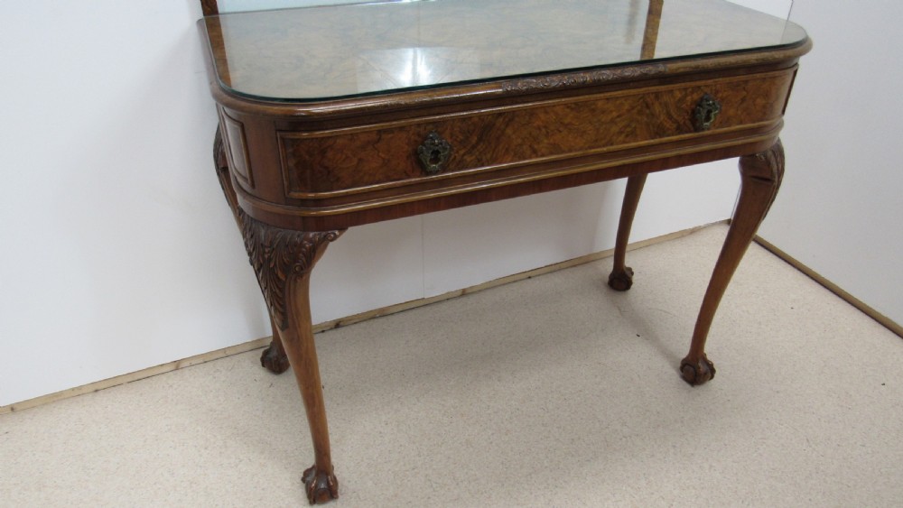 An antique burr walnut side table featuring cabriole legs with claw and ball feet, a single drawer, and a fitted glass top insert. View XVI