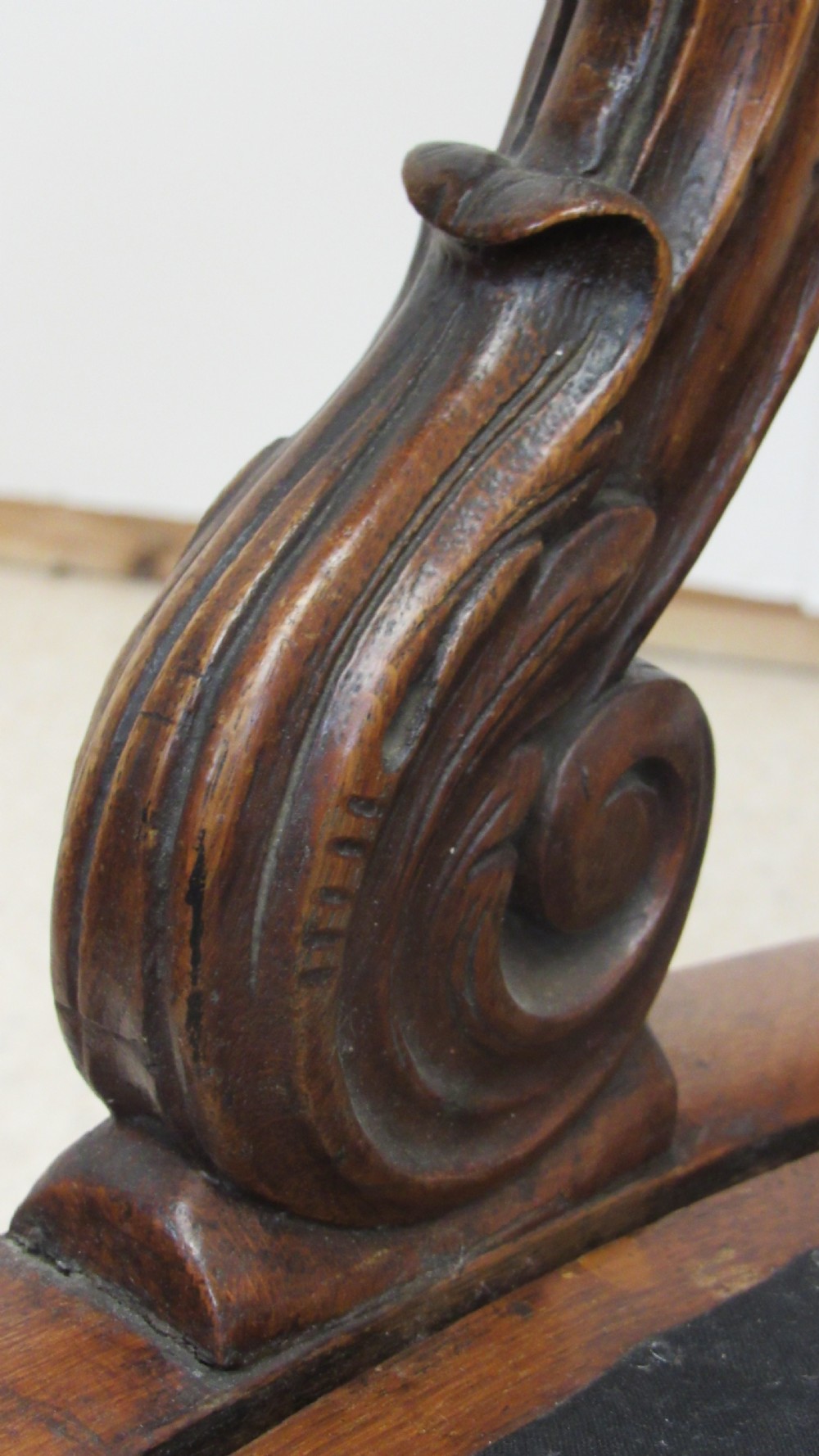 A William IV mahogany library chair upholstered in deep-buttoned olive green leather with padded scroll arms and turned front legs on brass castors. View VIII