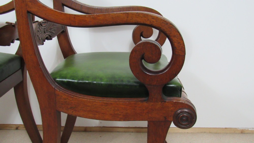 A pair of carved mahogany armchairs featuring scroll-carved top rails, curved armrests, reeded front rails, and green leather upholstered seats. View III