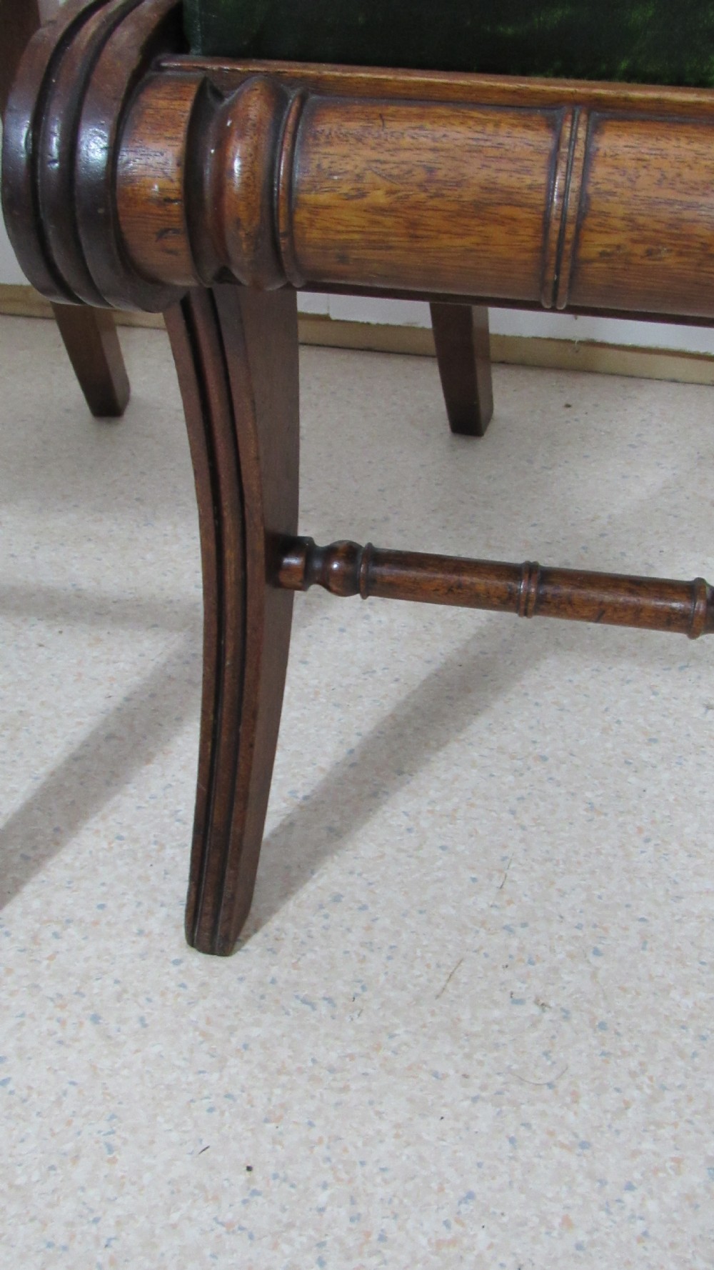A pair of carved mahogany armchairs featuring scroll-carved top rails, curved armrests, reeded front rails, and green leather upholstered seats. View XI