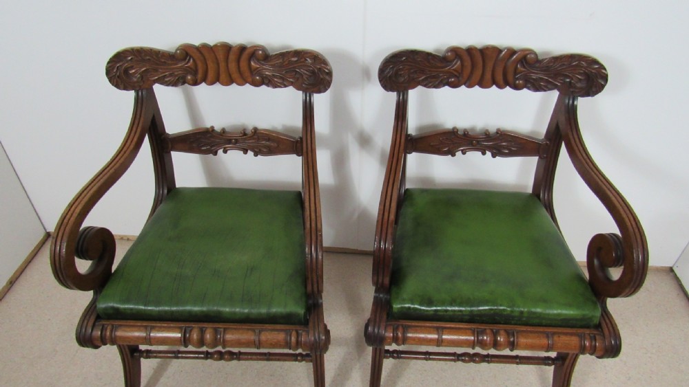 A pair of carved mahogany armchairs featuring scroll-carved top rails, curved armrests, reeded front rails, and green leather upholstered seats. View XIV