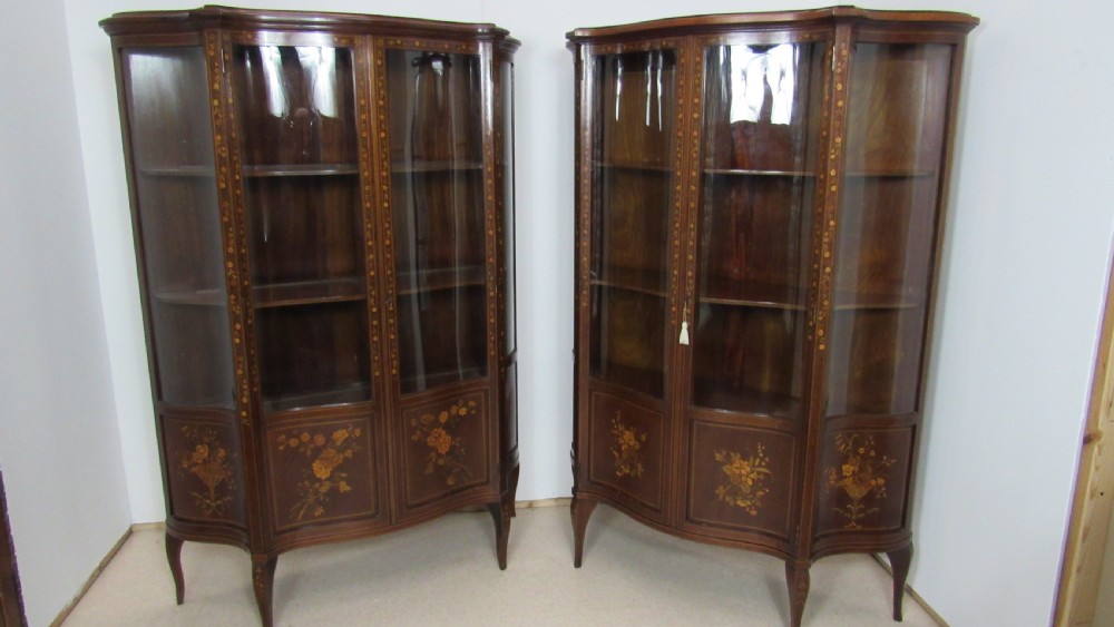 Wonderful Edwardian pair of serpentine  inlaid display cabinets 