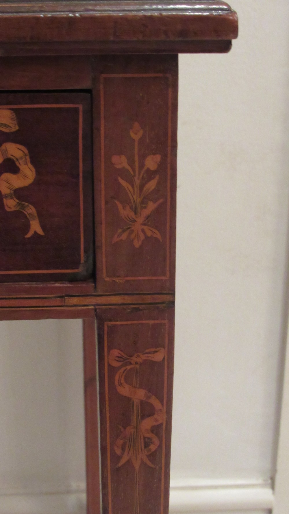 An Edwardian mahogany writing desk featuring detailed floral marquetry inlays, a green leather top, and raised stationery boxes with brass galleries. View IX
