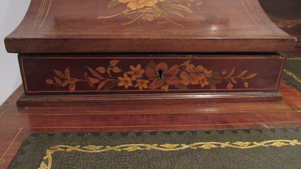 An Edwardian mahogany writing desk featuring detailed floral marquetry inlays, a green leather top, and raised stationery boxes with brass galleries. View XIII