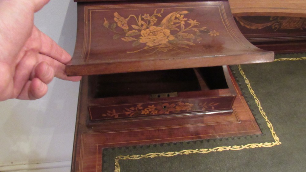 An Edwardian mahogany writing desk featuring detailed floral marquetry inlays, a green leather top, and raised stationery boxes with brass galleries. View XIV