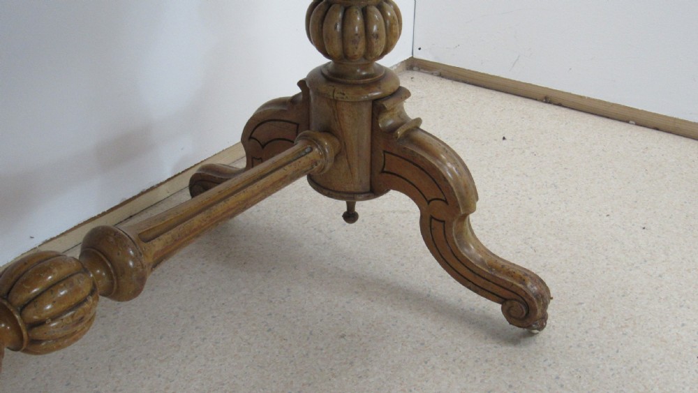 A Victorian satin walnut library table featuring a rectangular top with rounded corners, a pulled-out frieze drawer, turned pedestal legs, and a low central stretcher base. View IX
