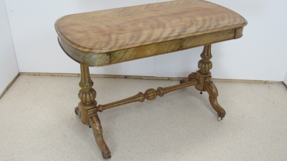 A Victorian satin walnut library table featuring a rectangular top with rounded corners, a pulled-out frieze drawer, turned pedestal legs, and a low central stretcher base. View XIII