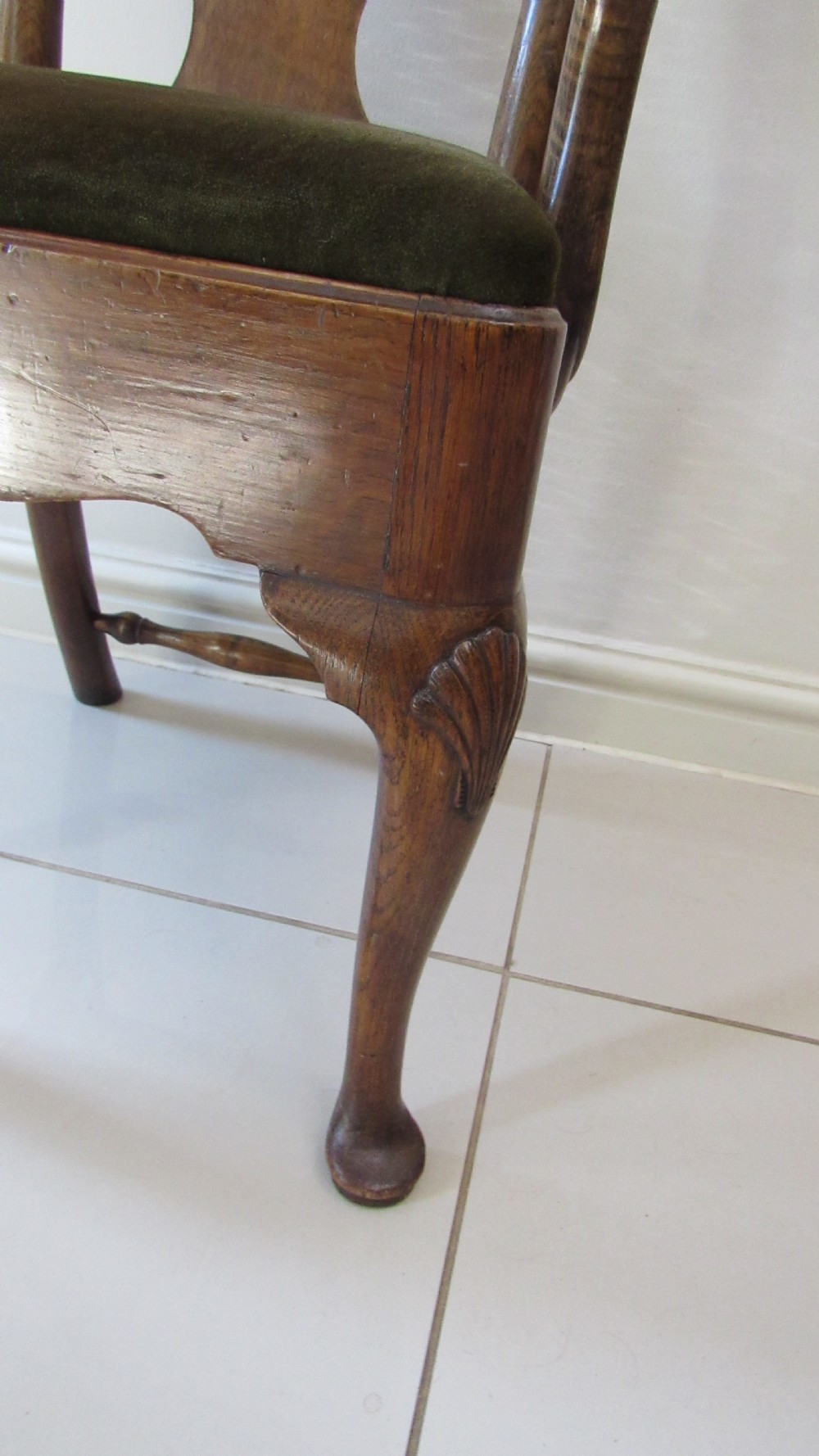 A miniature Queen Anne style childs armchair crafted from dark wood with a carved shell top rail, vasiform splat back, cabriole front legs, and a dark green velvet padded seat. View II