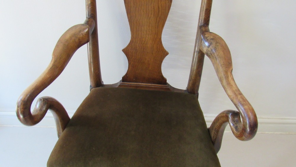 A miniature Queen Anne style childs armchair crafted from dark wood with a carved shell top rail, vasiform splat back, cabriole front legs, and a dark green velvet padded seat. View VI