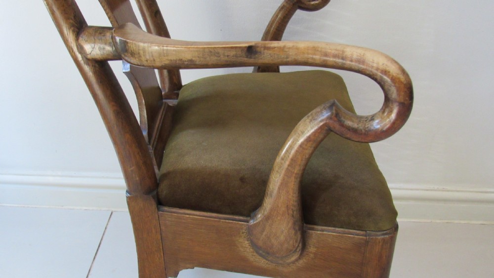 A miniature Queen Anne style childs armchair crafted from dark wood with a carved shell top rail, vasiform splat back, cabriole front legs, and a dark green velvet padded seat. View VIII