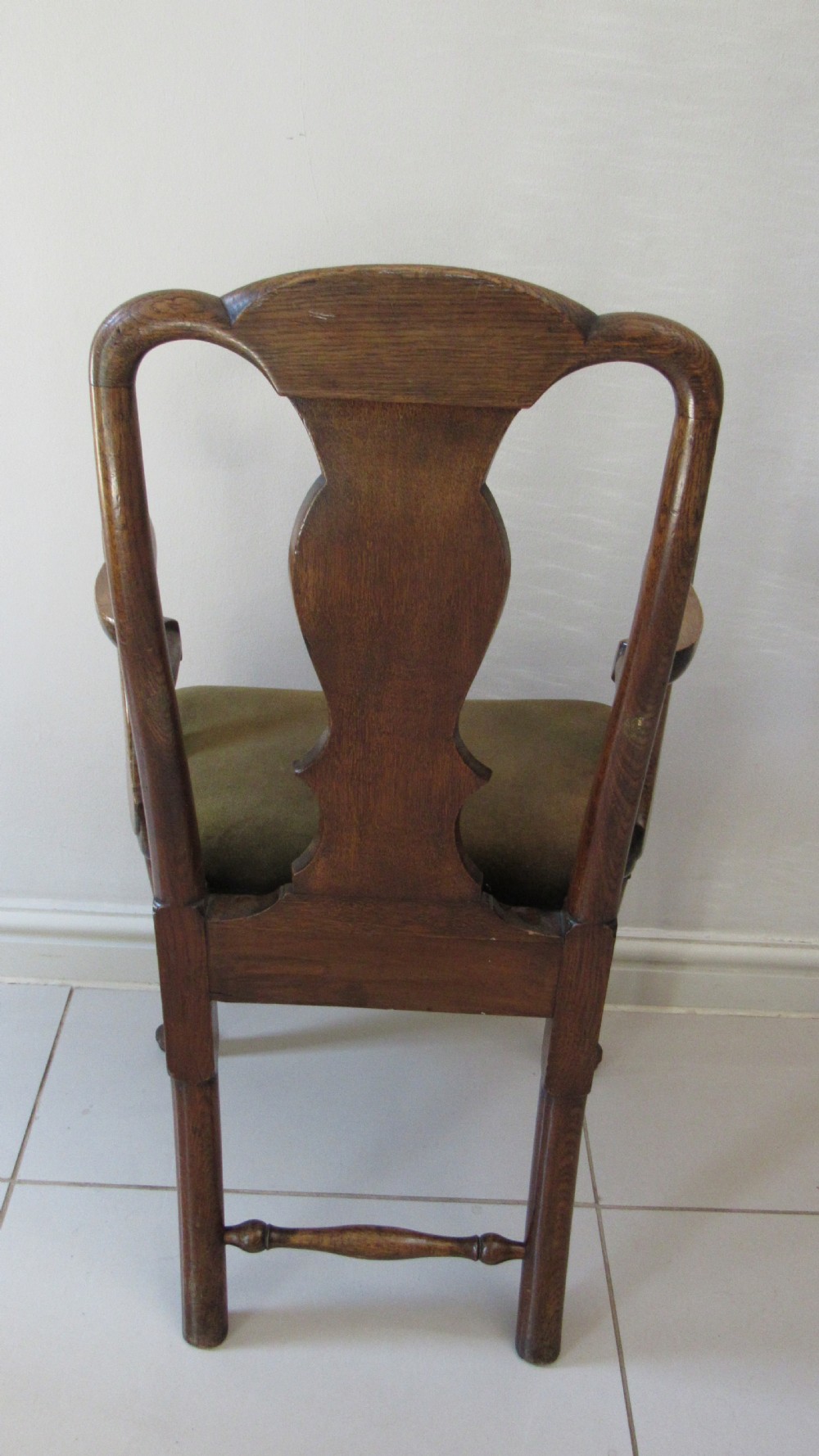 A miniature Queen Anne style childs armchair crafted from dark wood with a carved shell top rail, vasiform splat back, cabriole front legs, and a dark green velvet padded seat. View IX
