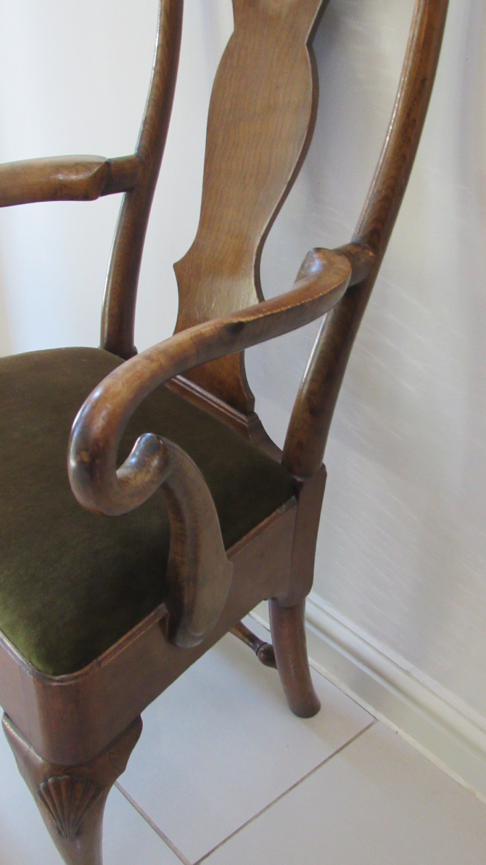 A miniature Queen Anne style childs armchair crafted from dark wood with a carved shell top rail, vasiform splat back, cabriole front legs, and a dark green velvet padded seat. View XI