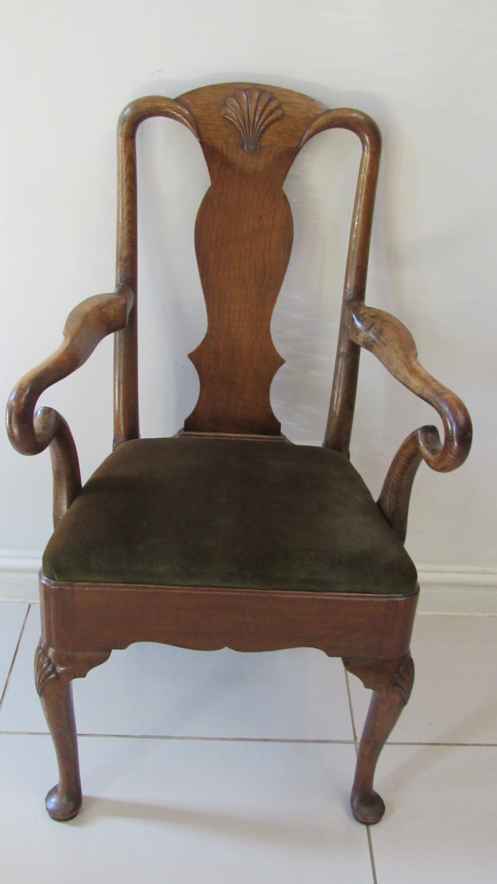 A miniature Queen Anne style childs armchair crafted from dark wood with a carved shell top rail, vasiform splat back, cabriole front legs, and a dark green velvet padded seat. View XIII