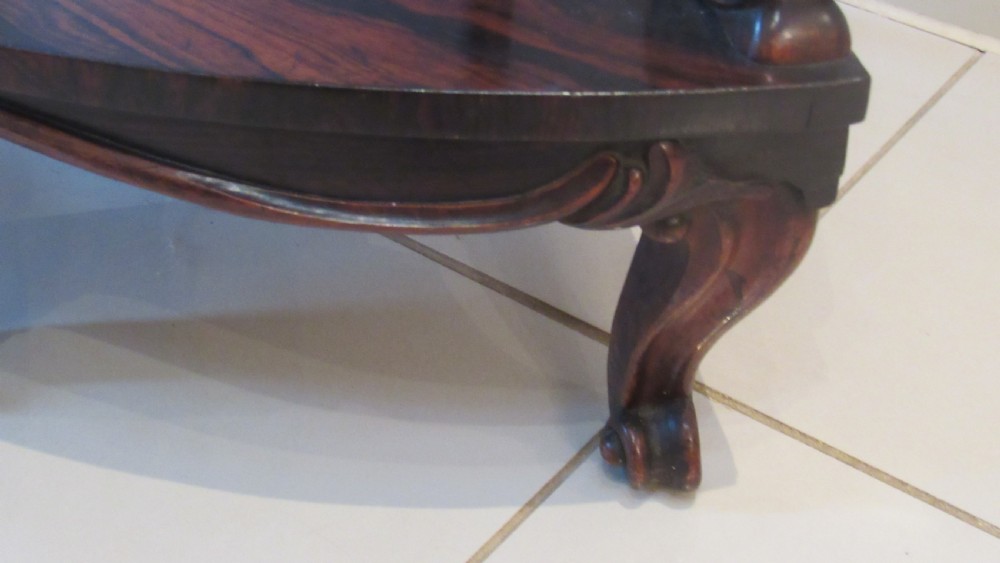 A three-tiered Victorian rosewood corner whatnot featuring intricate carved fretwork galleries, serpentine supports, and small carved feet. View XVII