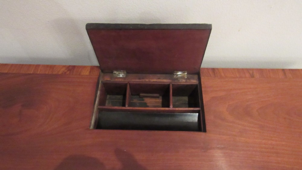 A Georgian mahogany chamber table featuring a rectangular top with a central flap, a single frieze drawer with brass hardware, and spiral turned legs on brass castors. View VII