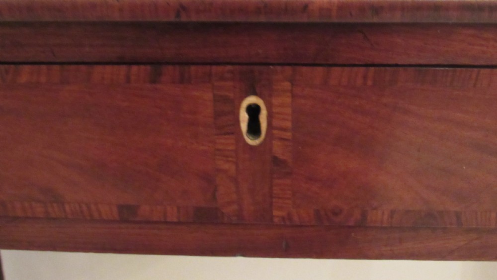 A Georgian mahogany chamber table featuring a rectangular top with a central flap, a single frieze drawer with brass hardware, and spiral turned legs on brass castors. View XII