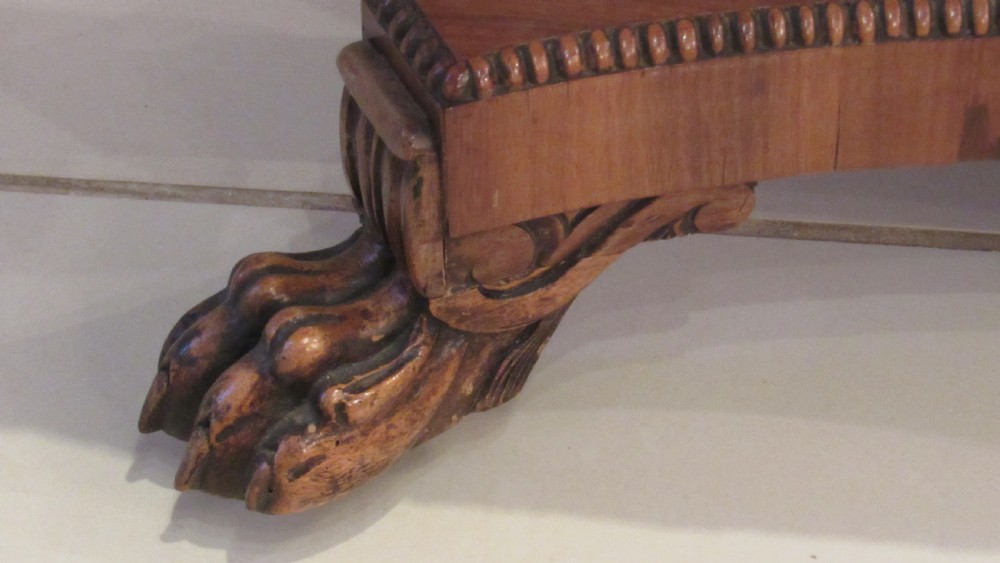 A William IV flame mahogany work table featuring drop-leaf side flaps, drawers with keyholes, a pleated pink fabric work well, and a quadruped base with carved paw feet. View VIII
