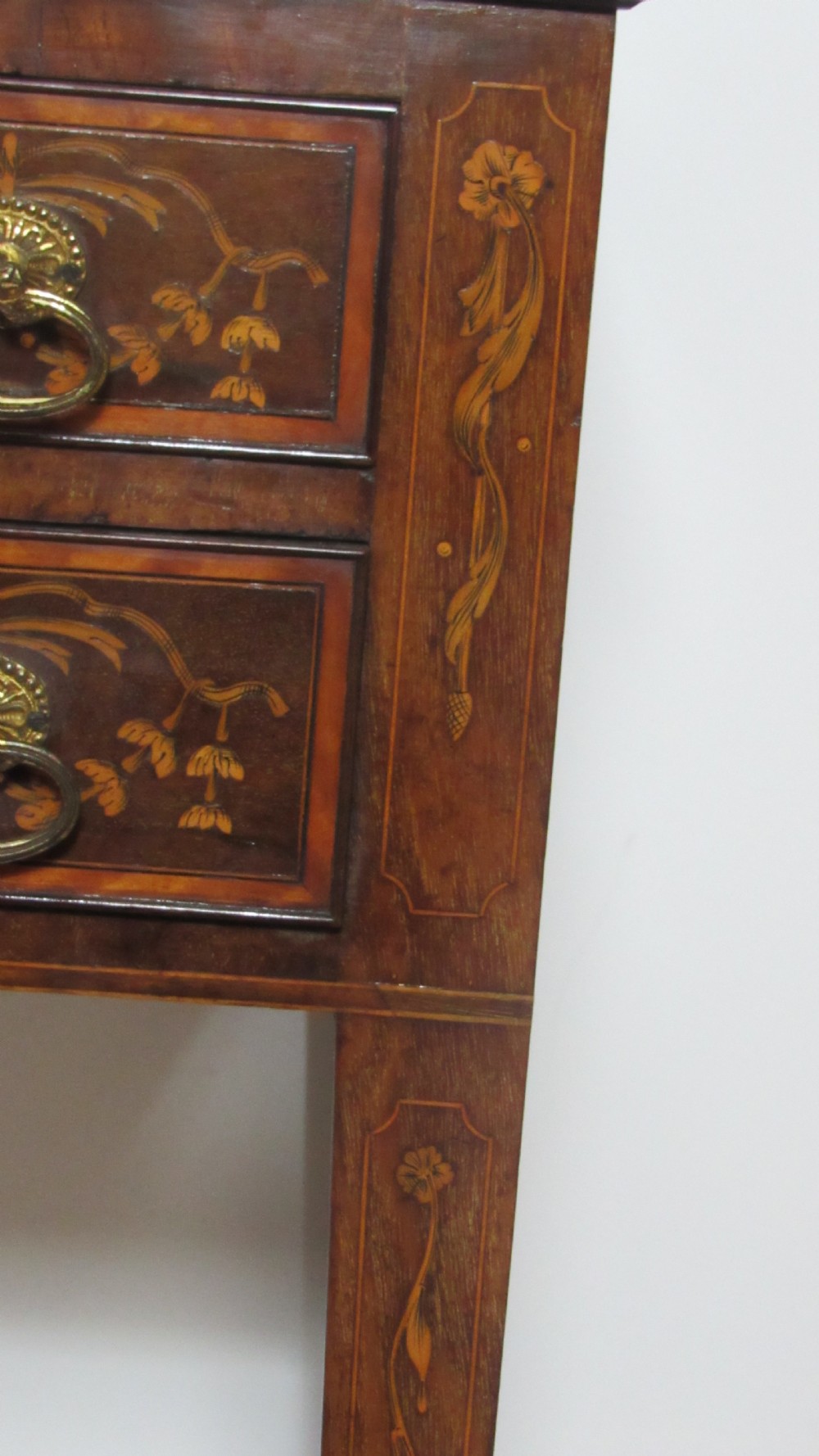 An antique mahogany glazed display cabinet featuring marquetry inlay, two glass doors, four small drawers, and square tapered legs. View IX