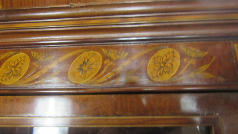 An antique mahogany glazed display cabinet featuring marquetry inlay, two glass doors, four small drawers, and square tapered legs. View XVIII