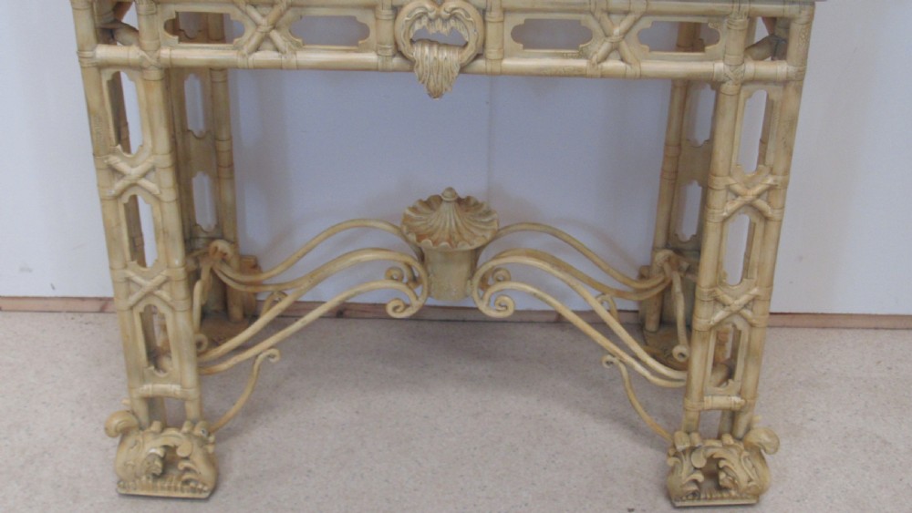 A cream painted Chinoiserie display cabinet on a stand featuring a pagoda-style roof, diamond lattice glass doors, and faux bamboo detailing. View VII