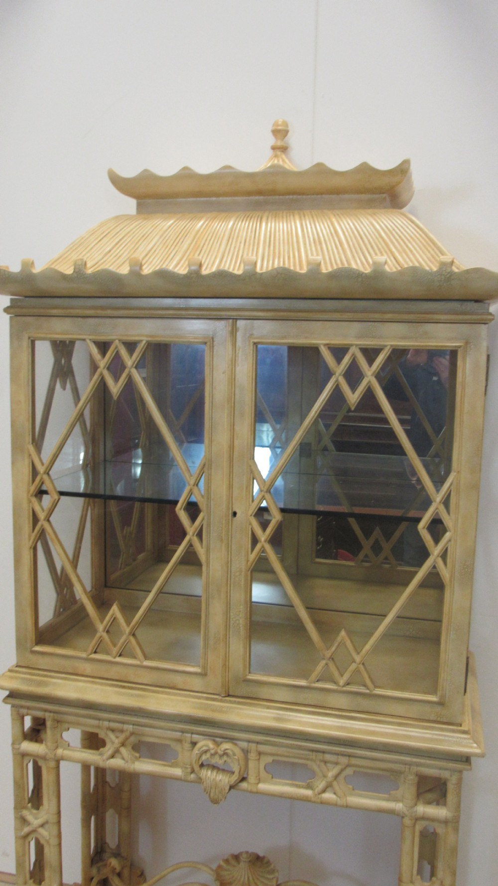 A cream painted Chinoiserie display cabinet on a stand featuring a pagoda-style roof, diamond lattice glass doors, and faux bamboo detailing. View IX