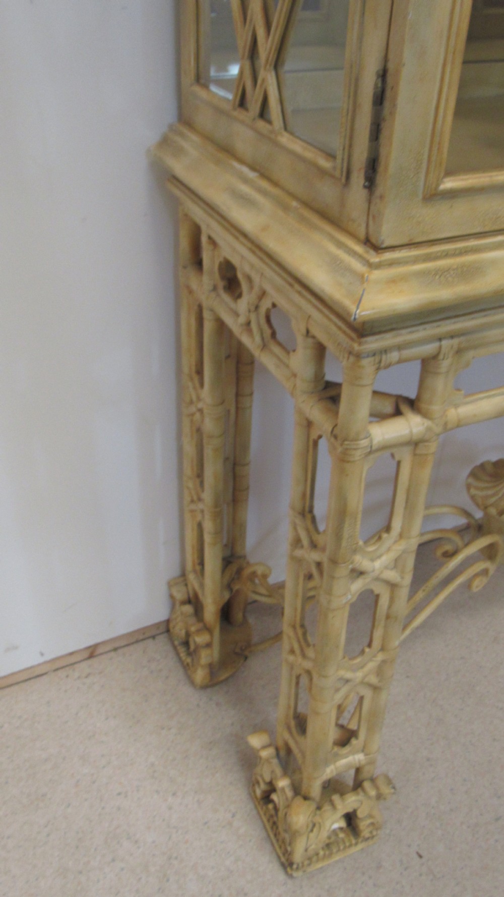 A cream painted Chinoiserie display cabinet on a stand featuring a pagoda-style roof, diamond lattice glass doors, and faux bamboo detailing. View XVII