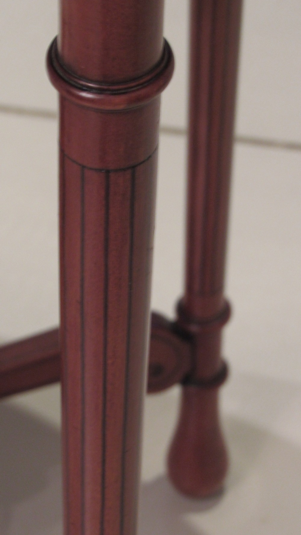 An oval antique satinwood occasional table featuring decorative marquetry inlay on top, tapered legs, and a small lower shelf with a brass gallery rail. View XVI
