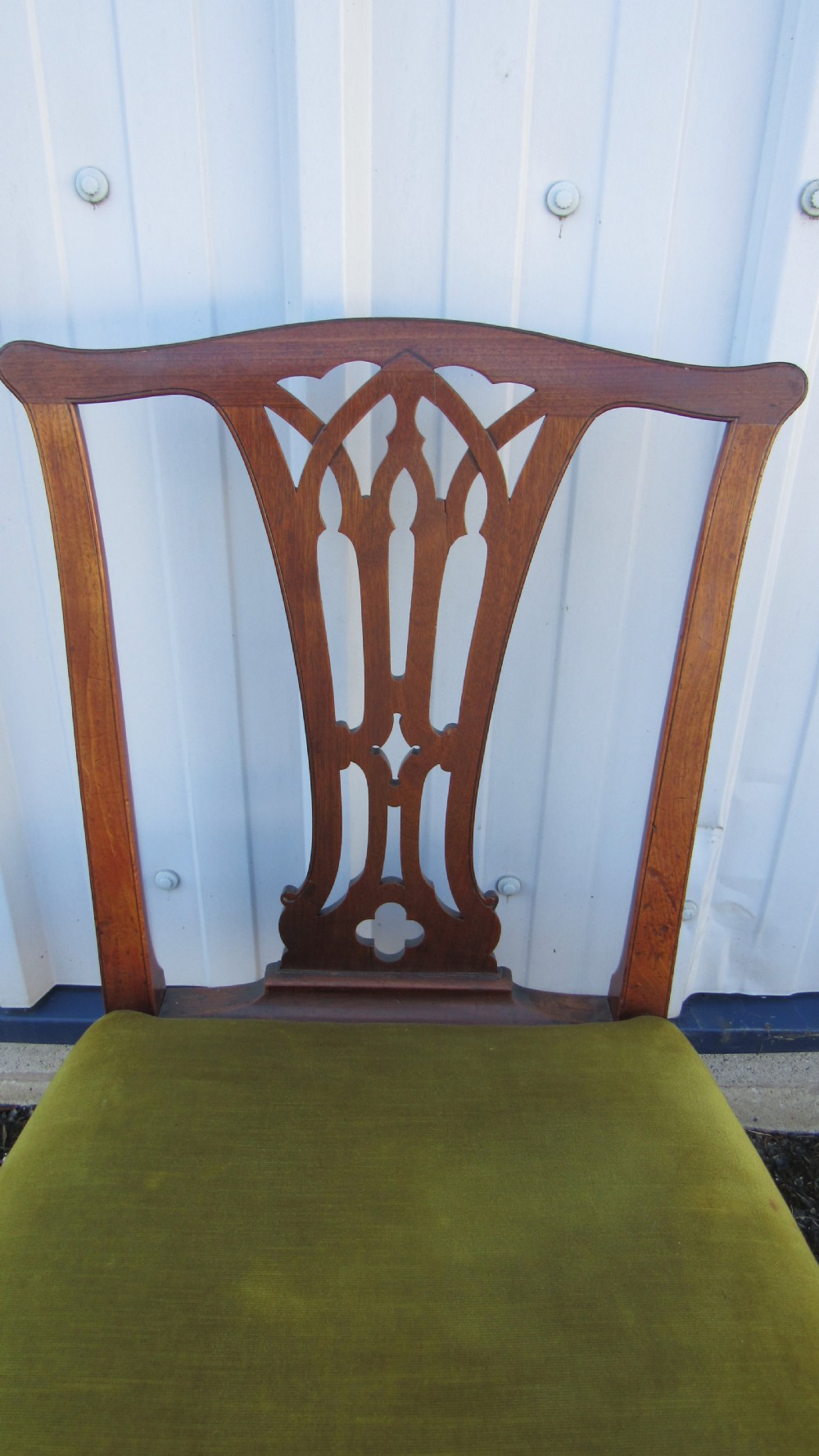 Set of four Georgian mahogany dining chairs featuring carved pierced splats and green velvet upholstered seats. View III