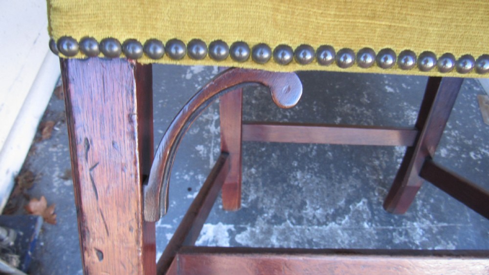 Set of four Georgian mahogany dining chairs featuring carved pierced splats and green velvet upholstered seats. View IV