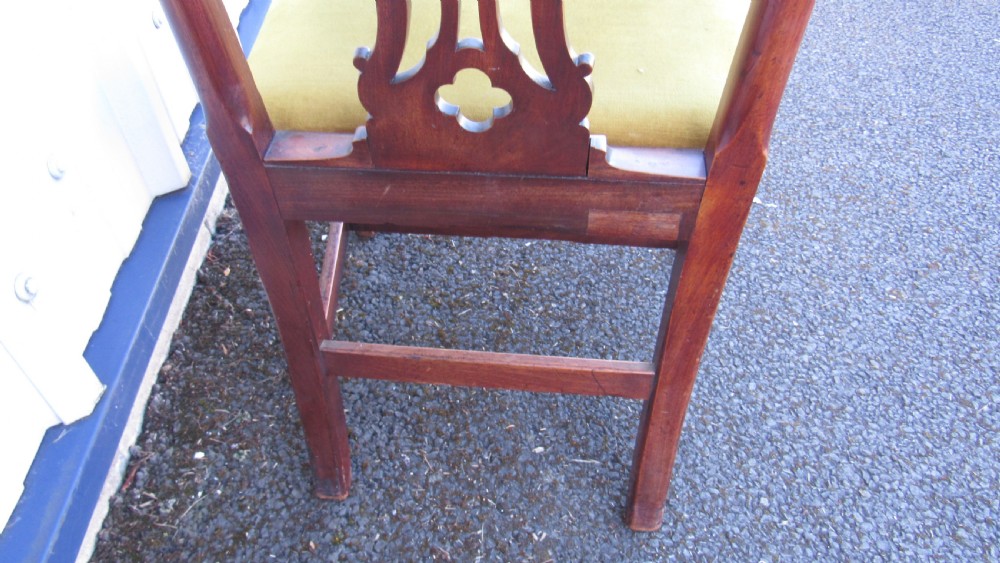 Set of four Georgian mahogany dining chairs featuring carved pierced splats and green velvet upholstered seats. View IX