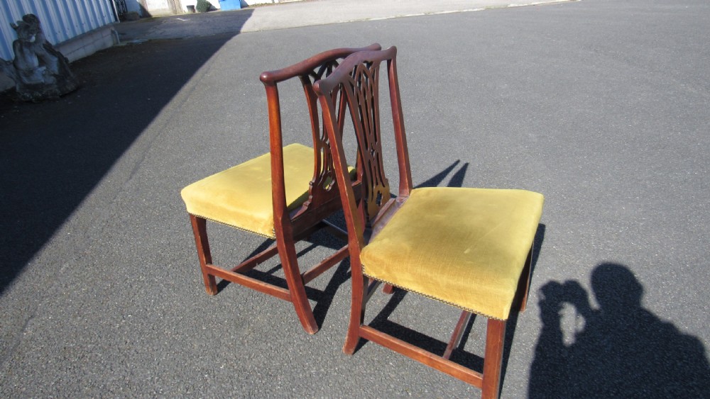 Set of four Georgian mahogany dining chairs featuring carved pierced splats and green velvet upholstered seats. View XI