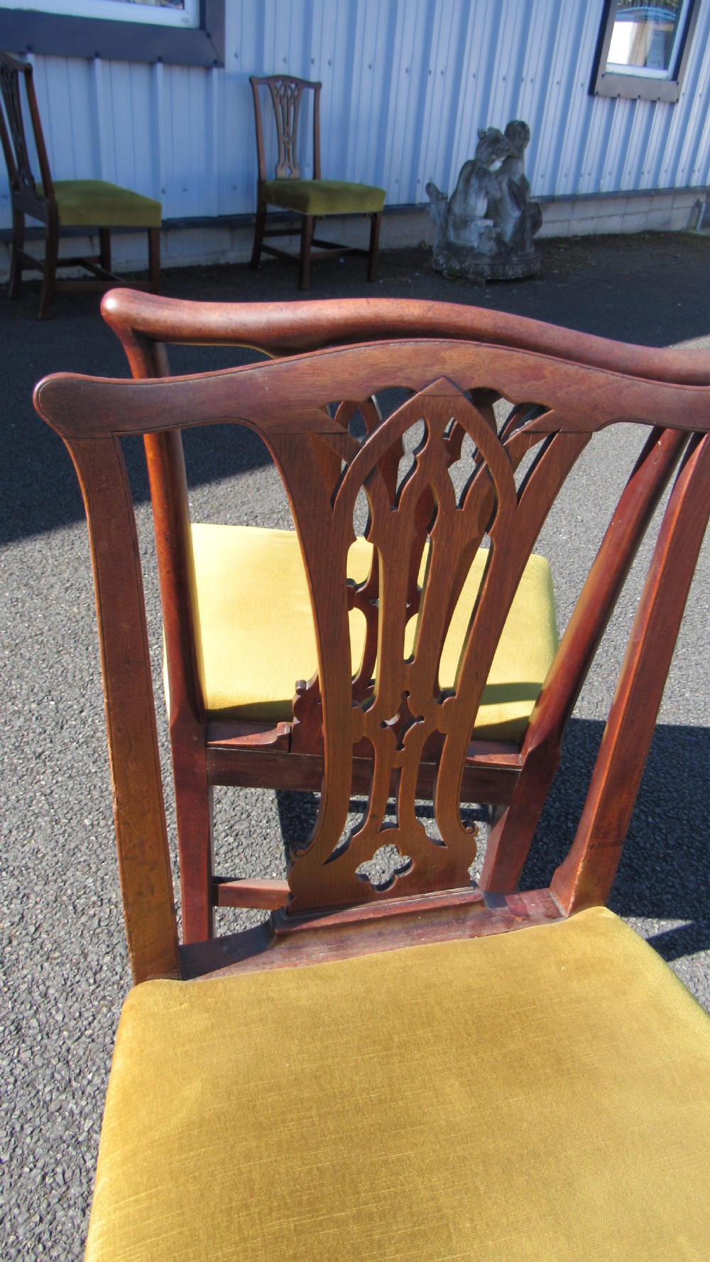 Set of four Georgian mahogany dining chairs featuring carved pierced splats and green velvet upholstered seats. View XII