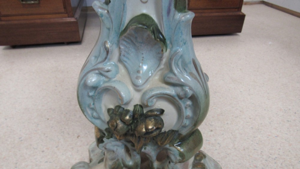A circular Art Nouveau pottery table featuring a hand-painted floral iris design on a cream-glazed top supported by a sculpted pedestal base. View XIV