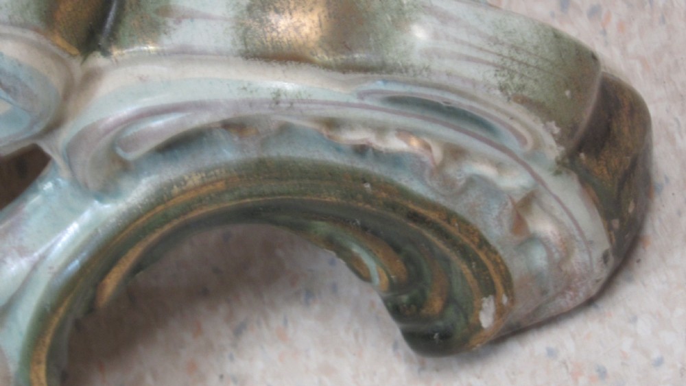 A circular Art Nouveau pottery table featuring a hand-painted floral iris design on a cream-glazed top supported by a sculpted pedestal base. View XXII