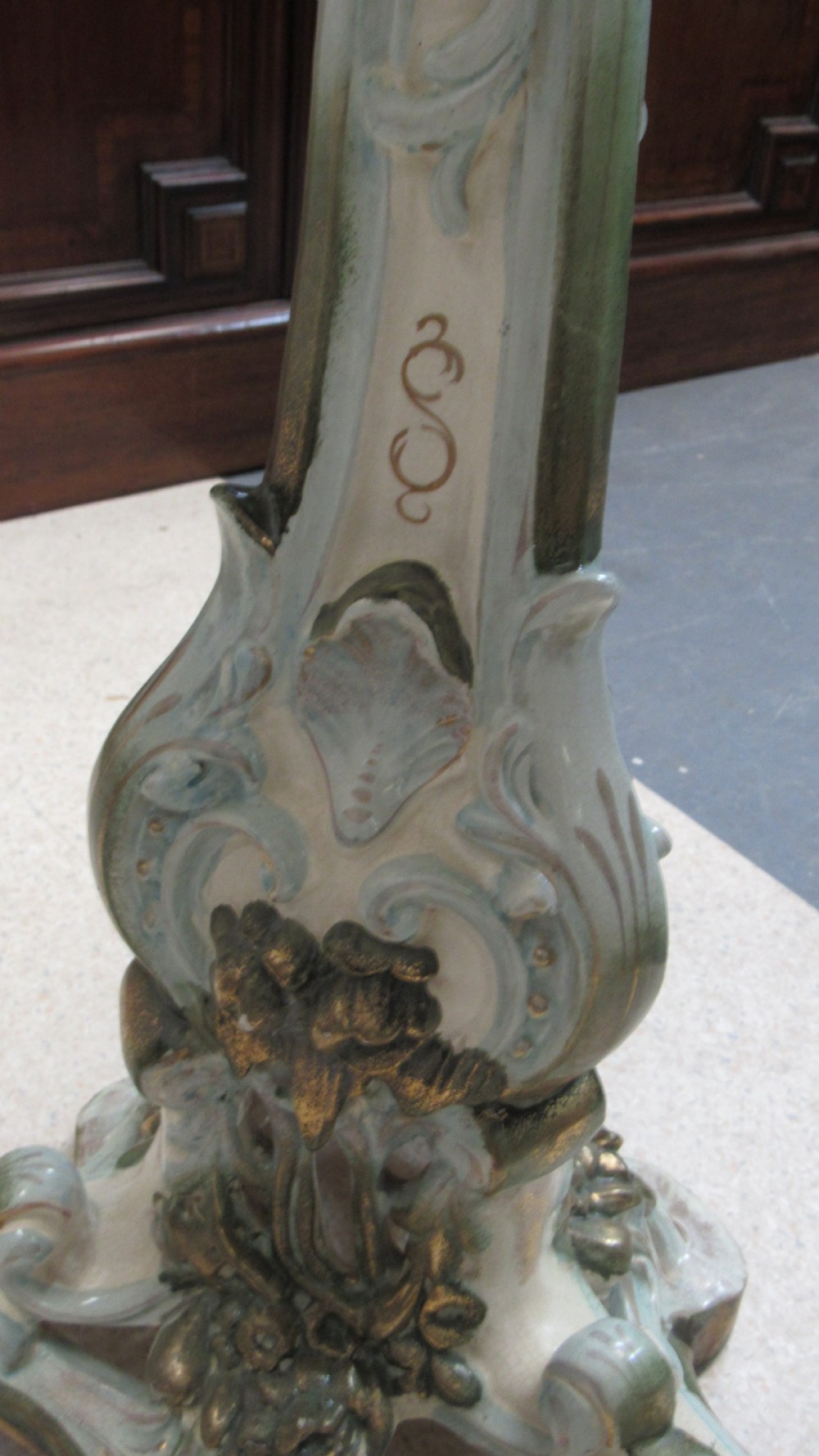 A circular Art Nouveau pottery table featuring a hand-painted floral iris design on a cream-glazed top supported by a sculpted pedestal base. View XXIII