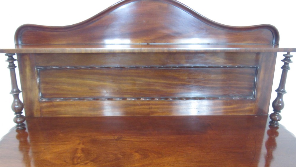A Victorian mahogany chiffonier featuring an upper gallery shelf with turned side supports above a two-door lower cabinet with arched moulded panels. View VIII