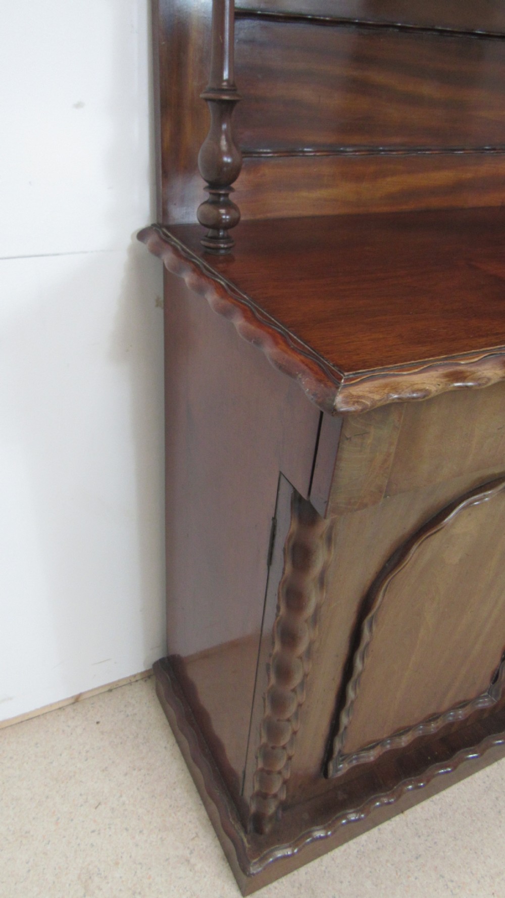 A Victorian mahogany chiffonier featuring an upper gallery shelf with turned side supports above a two-door lower cabinet with arched moulded panels. View XII