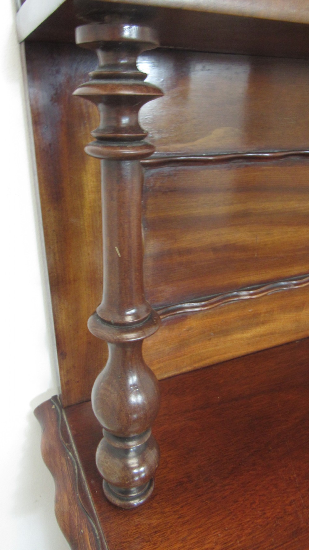 A Victorian mahogany chiffonier featuring an upper gallery shelf with turned side supports above a two-door lower cabinet with arched moulded panels. View XIII